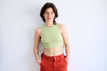 Smiling Woman in Green Top and Orange Pants