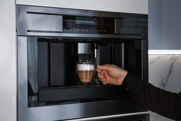 A man make coffee in integrated built-in coffee machine