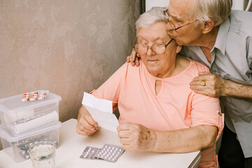 Elderly Couple Reading Medicine Instructions Together