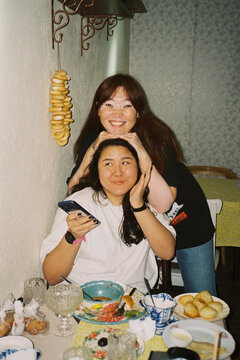 Two women smiling in a cafe