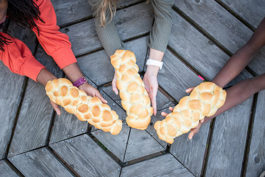 Girls holding Challah loaves