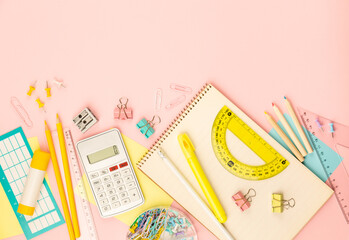 stationery items for girls or women on light pink background. Back to school. Female Student's, pupil's or engineer's supplies. Office objects on pastel pink background. Calculator, pen, pencil etc.