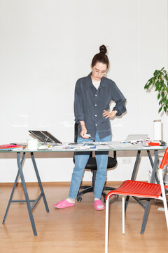 Woman Reviewing Payment Receipt at Desk