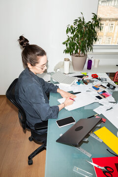 Designer Working on Sketches at Office Desk