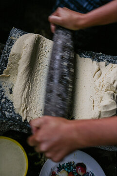 Kneading corn masa with a stone roller Guatemala