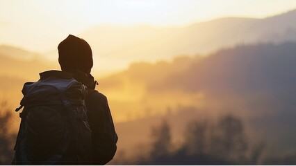  a solitary tourist with a backpack, gazing out over a mountain landscape at dawn, their silhouette...
