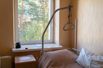 Bed With Trapeze Bar In The Room