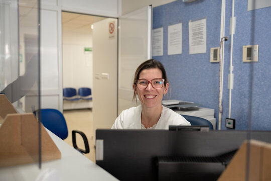 Friendly receptionist at health clinic desk