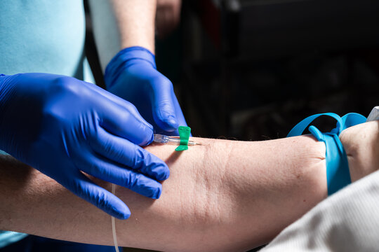 Medical professional drawing blood from patient's arm