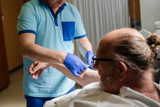 nurse applying an adhesive bandage on a patient