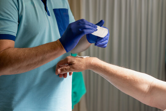 Medical professional applying bandage after vaccination