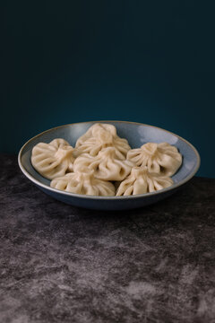 Traditional khinkali on dark surface. Georgian cuisine captured 
