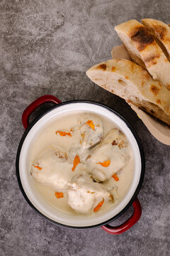 Traditional Georgian Shkmeruli dish with bread on the side
