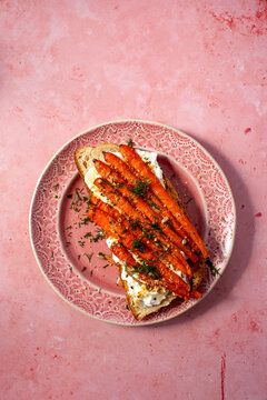 A dish of roasted carrots with whipped feta on toast