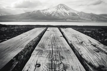 A wooden bench is shown with a mountain in the background