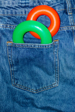 Color geometric shape torus in denim jeans pocket with hard flashlight