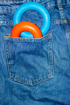 Color geometric shape torus in denim jeans pocket with hard flashlight