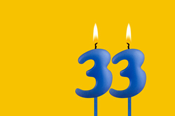 Blue candle number 33 - Birthday on yellow background