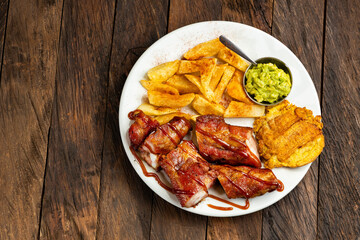 Grilled mamona beef with fries and patacon plantain - Typical Colombian food