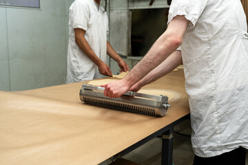 Rolling Pin Perforating Matzah Dough.
