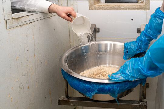 Mixing Dough For Shmura Matzah. Water Mixing Into Matzah Flour.