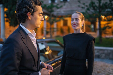 romantic date of young couple dressed elegantly at night