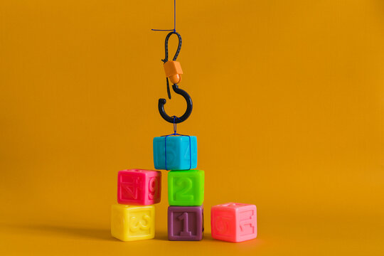 Сolorful plastic cubes with numbers lined up move with a hook