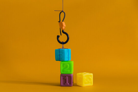 Сolorful plastic cubes with numbers lined up move with a hook