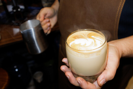 barista holding coffee in hand