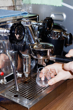 barista preparing coffee in coffee maker