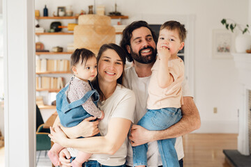 portrait of smiling and happy family in dining room .