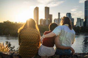 Three friends watching the sunset in Brisbane