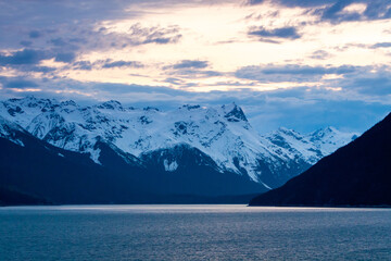 Snow-capped mountains at dusk along the Chilkoot Inlet in Alaska