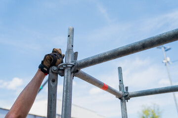 Building modular scaffolding systems with ringlock locking system, professional builders hand...