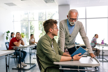 Students listening to an older high school teacher.