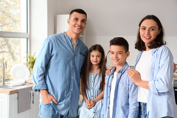 Fototapeta premium Little children with their parents in kitchen