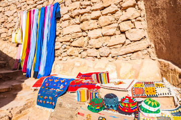 Traditional Moroccan souvenirs for sale in narrow street of Ksar Ait Ben Haddou, old Berber ancient...