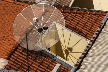Satellite dish on the roof tile.Parabolic antenna, an antenna for catching domestic and foreign TV...