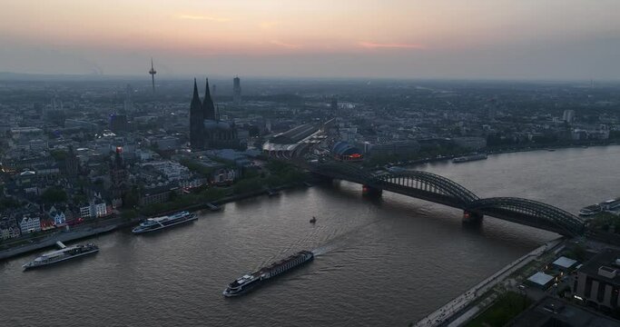 Cologne city skyline, cologne cathedral, bridge and city center at sunset.