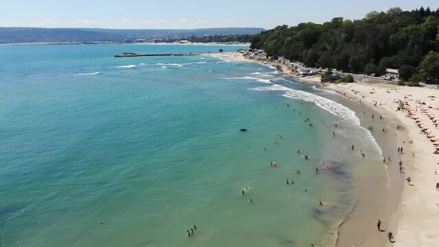Panoramic aerial drone top view of beach, seashore, umbrellas, coastline  and hotels in Varna, Bulgaria, near Golden Sands. Popular summer resort  near Varna on Black sea. Summer holiday destination in