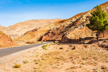 Empty paved asphalt road in Atlas mountains with high peaks and desert arid landscape near Telouet...