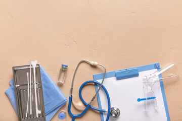 Clipboard with stethoscope, gynecological speculum and pap smear test tools on beige background