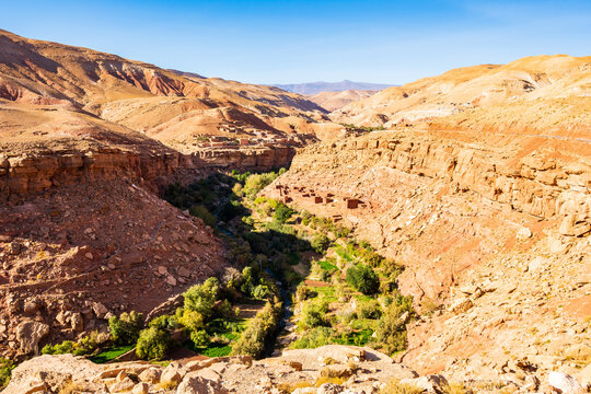 View of green oasis with palm trees and river in Dades valley between Telouet and Anmiter towns in Atlas Mountains, Morocco, North Africa