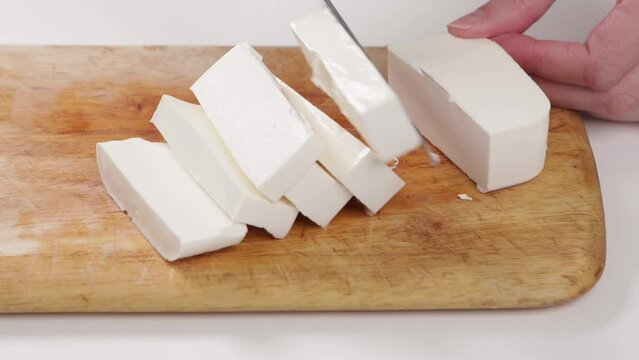 cutting feta cheese with knife