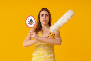 Woman with skin allergy, pp-duster and mite sign on yellow background