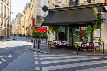 Cozy street with tables of cafe  in Paris, France. Cityscape of Paris. Architecture and landmarks...