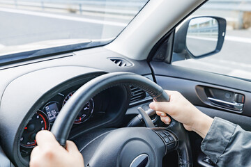 走行する車のハンドルを握る運転手