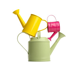 Color watering cans on white background