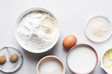 overhead view of mise en place for hot cross buns dough, ingredients for making hot cross buns on a...
