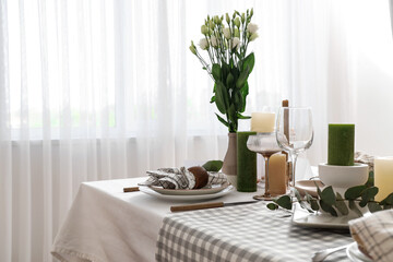 Beautiful table setting with eustoma flowers and eucalyptus for wedding celebration in room